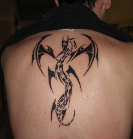 Impressive Black Tribal Dragon Tattoo On Man Upper Back