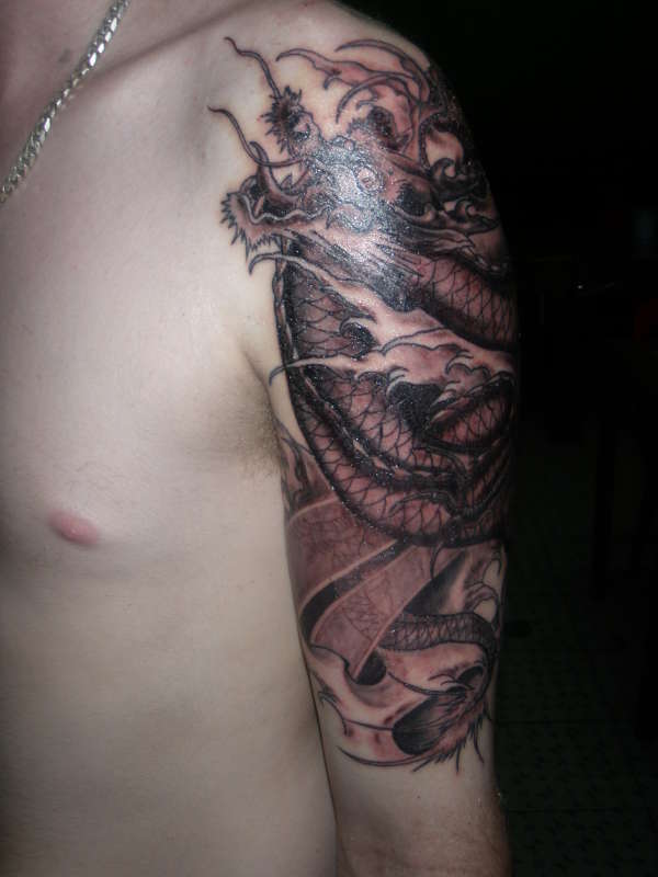 Inspiring Black Ink Dragon Tattoo On Man Left Half Sleeve