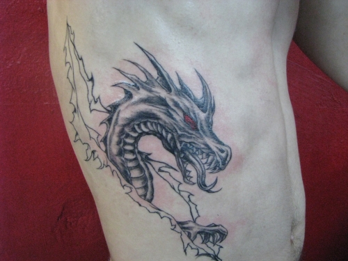 Latest Black Ink Dragon Tattoo On Man Right Side Rib