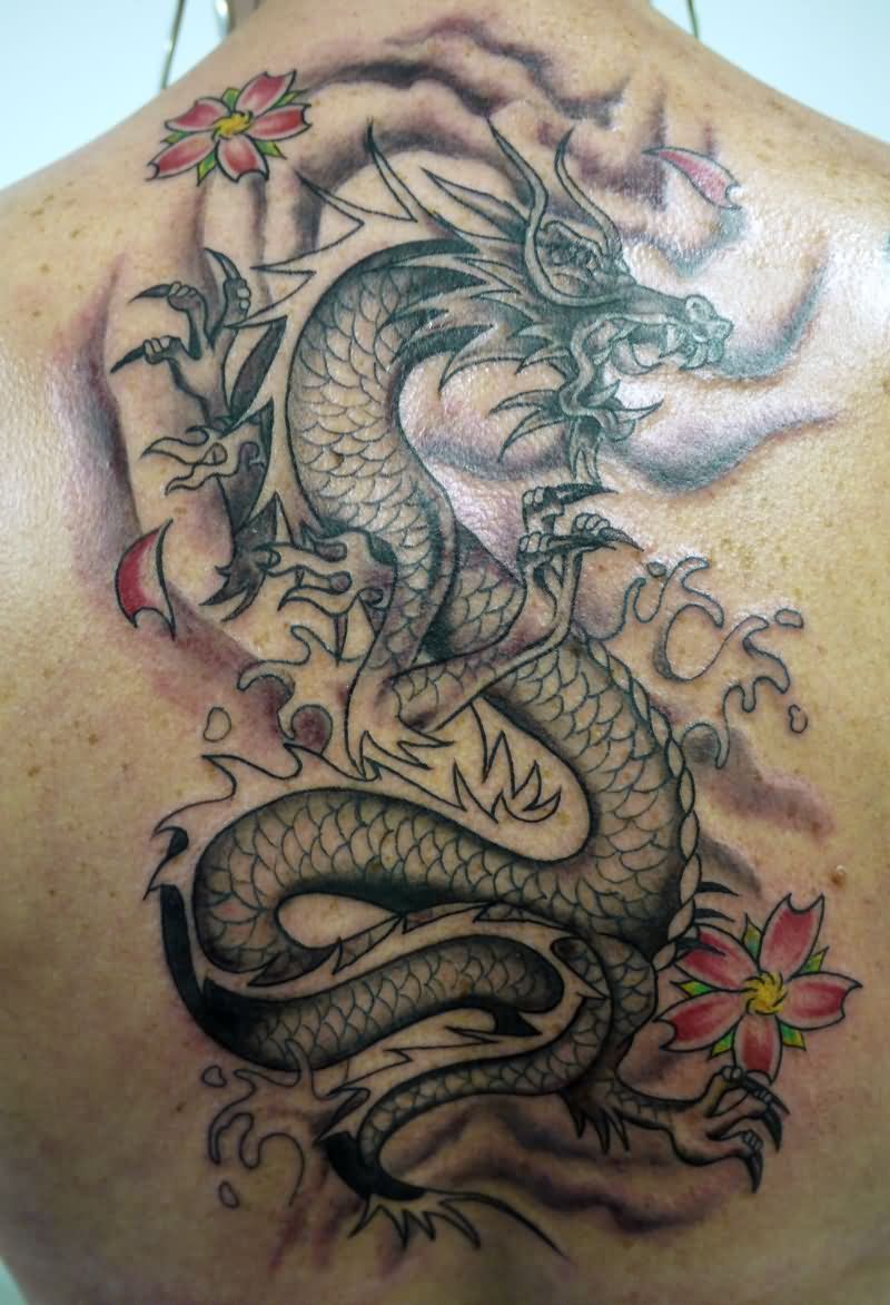 Latest Black Ink Dragon Tattoo On Man Upper Back