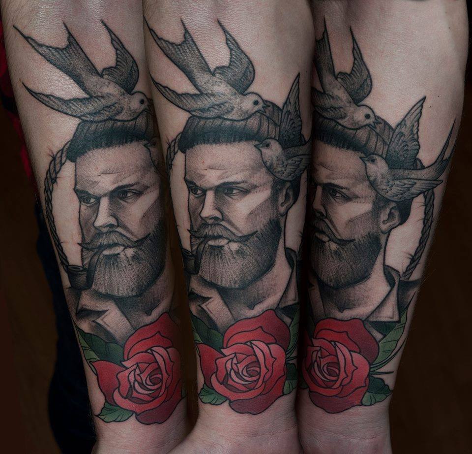 Man Face With Flying Bird And Rose Tattoo On Forearm