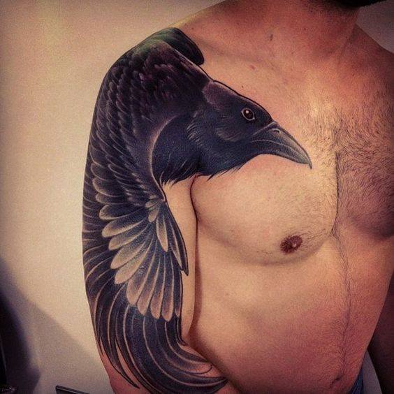 Man With Black Crow Tattoo On Right Sleeve