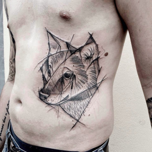 Man With Wolf Head Tattoo On Side Rib