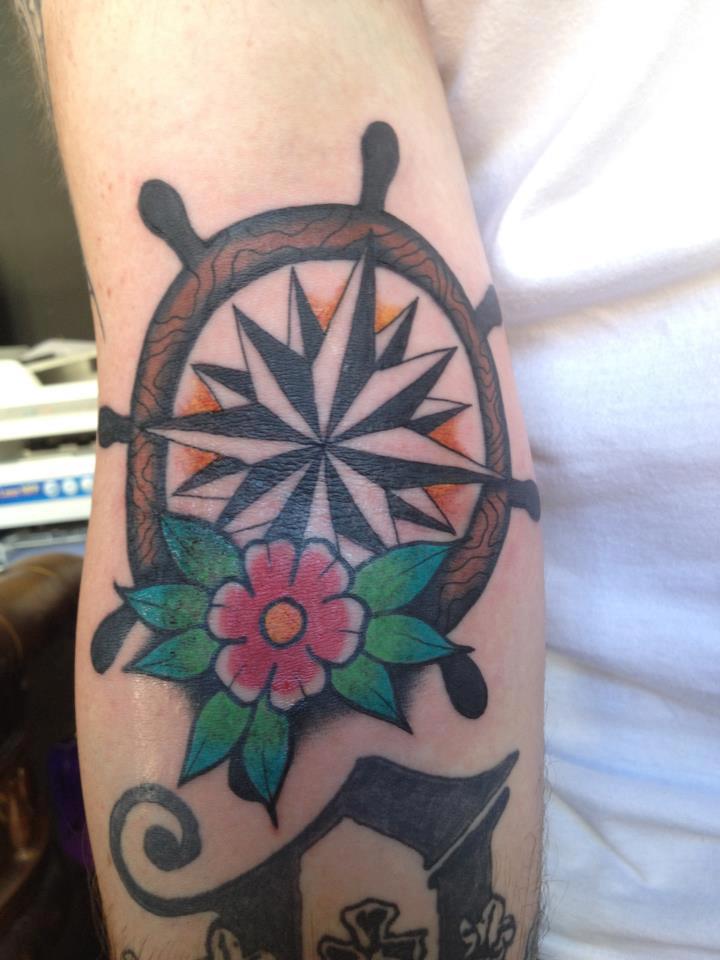 Nautical Star With Ship Wheel And Flower Tattoo On Forearm By Jay Thurley