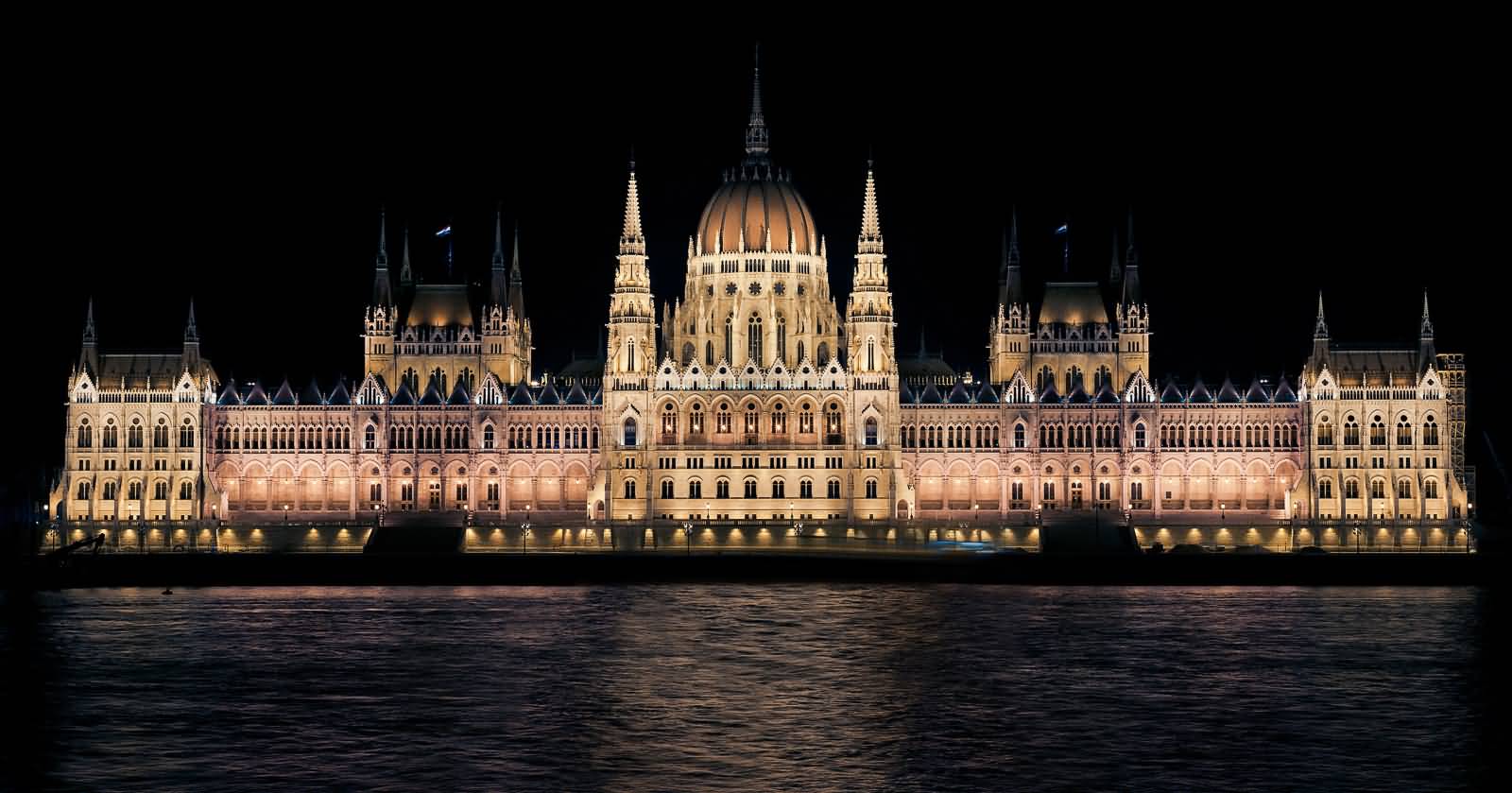 Night View Of Hungarian Parliament Building Across The Danube River