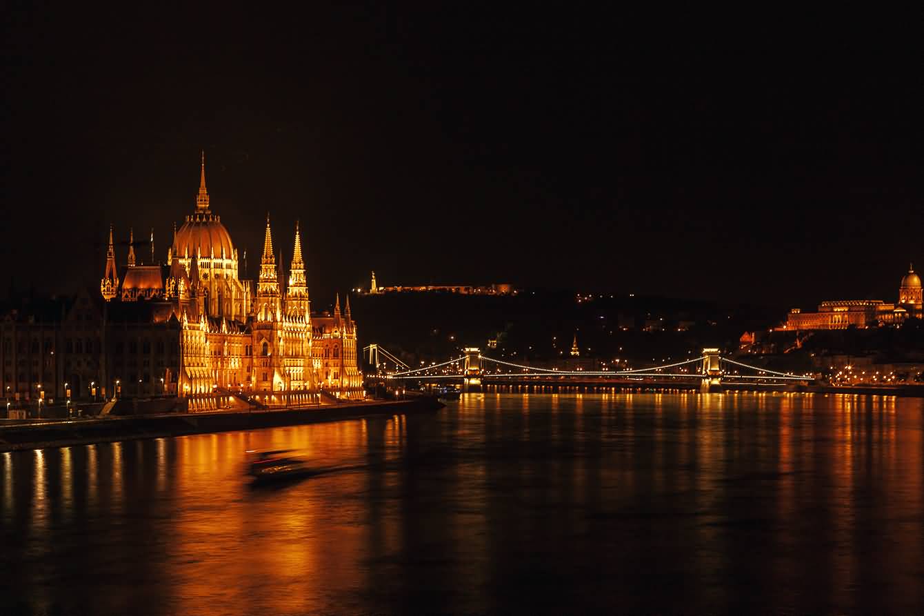 Night View Of Hungarian Parliament Building From Chain Bridge