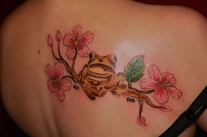 Pink Flowers And Frog Tattoo On Back