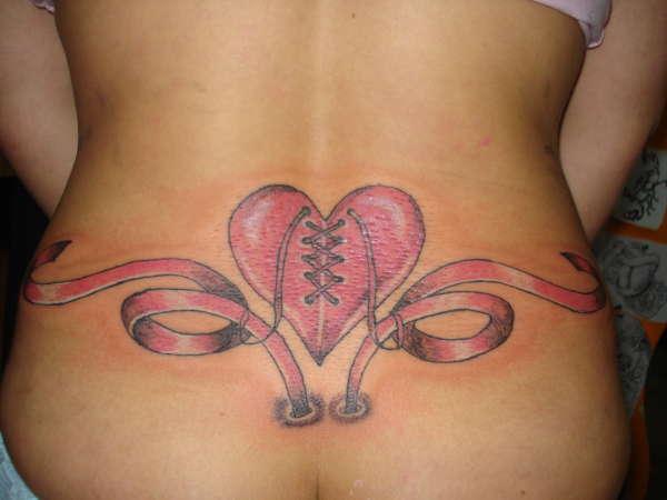 Pink Heart With Corset Tattoo On Lower Back