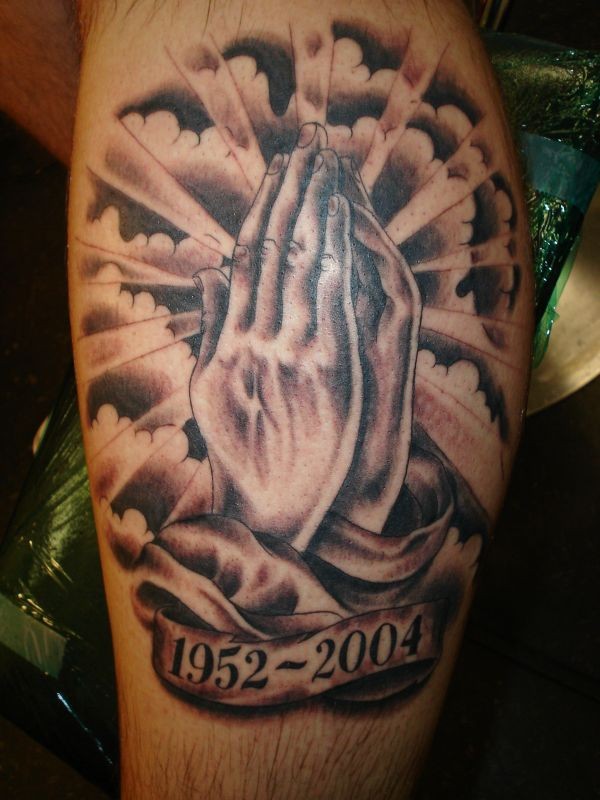 Praying Hands And Memorial Banner Tattoo On Back Leg