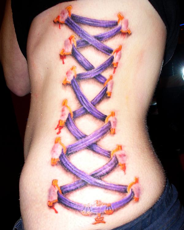 Purple Ink Corset Tattoo On Left Side Rib