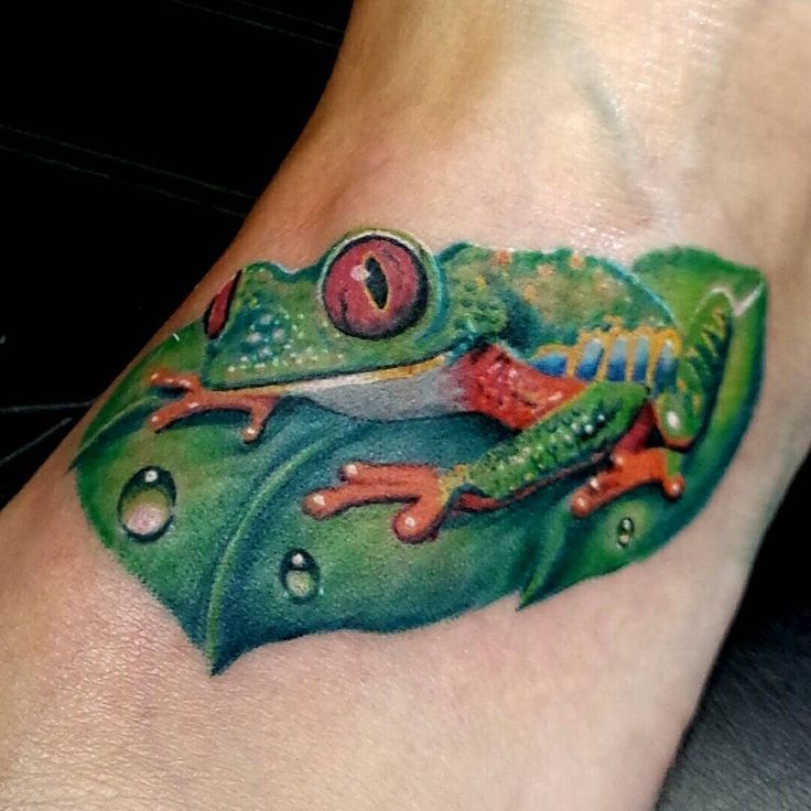 Realistic Leaf And Green Frog Tattoo On Left Foot
