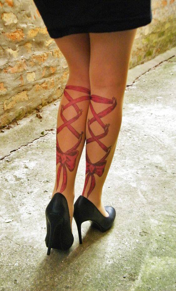 Red Ink Corset With Bow Tattoo On Girl Both Leg Calf
