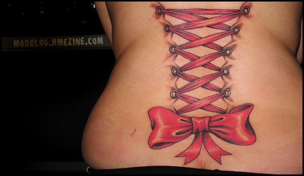 Red Ink Corset With Bow Tattoo On Lower Back