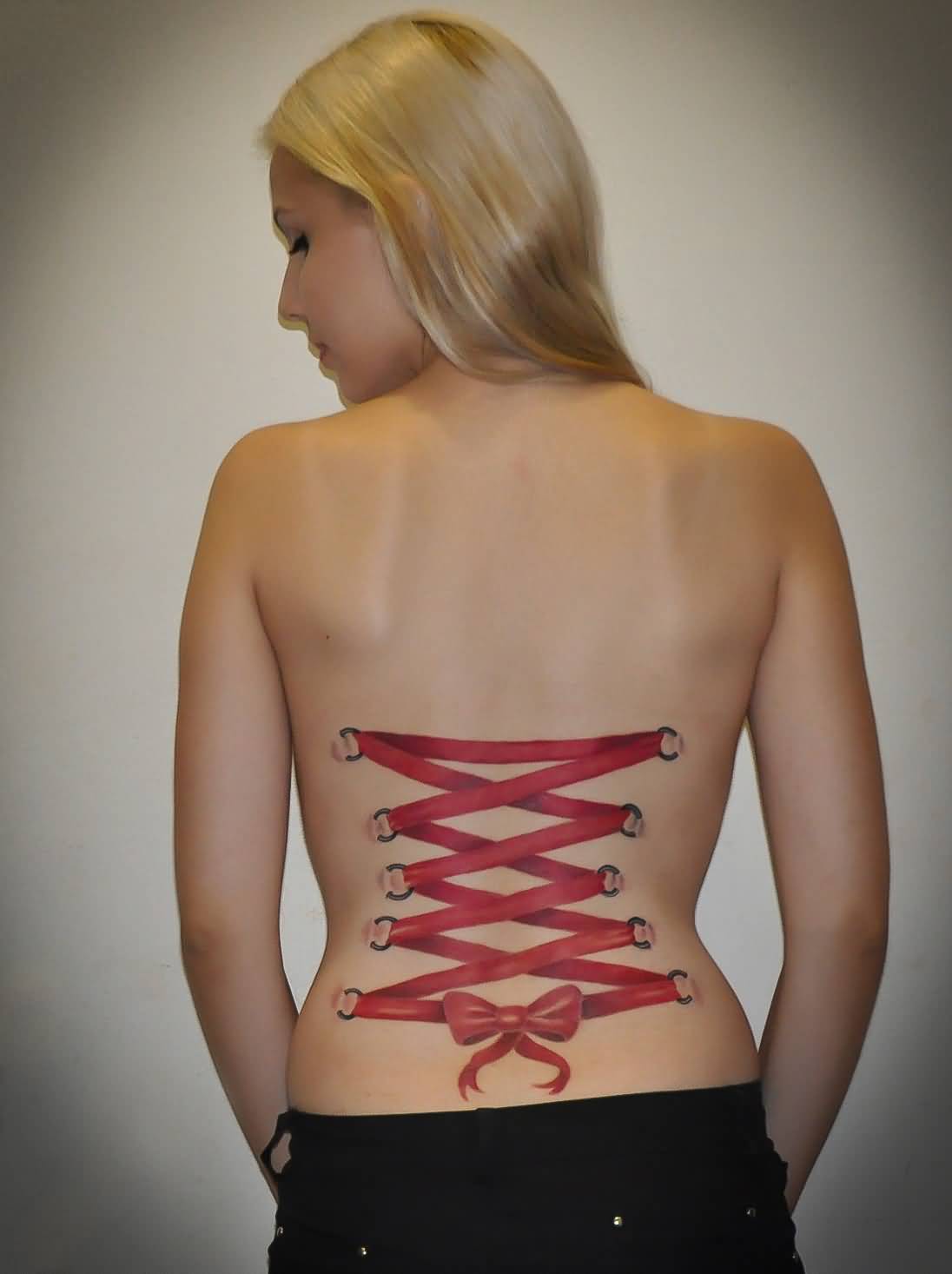 Red Ink Corset With Bow Tattoo On Women Full Back