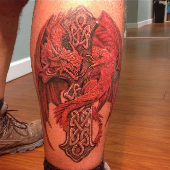 Red Ink Dragon With Celtic Cross Tattoo On Right Leg