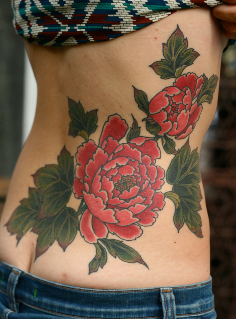 Red Ink Peony Flowers Tattoo On Women Lower Back