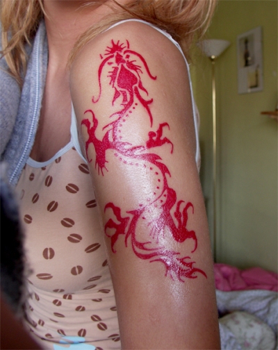 Red Ink Tribal Dragon Tattoo On Women Left Half Sleeve