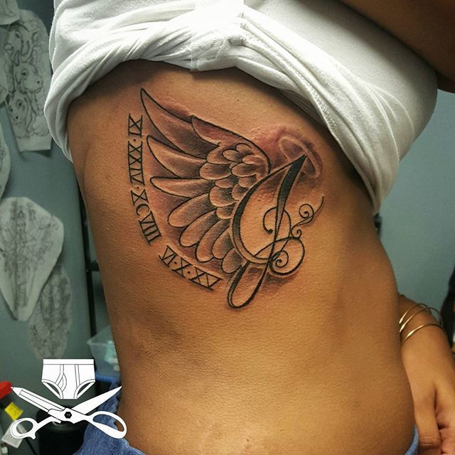 Roman Numerals With Angel Wings Memorial Tattoo On Side Rib