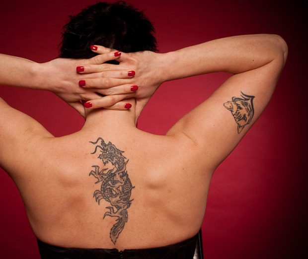 Simple Black Ink Dragon Tattoo On Women Upper Back