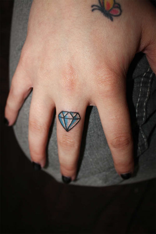 Small Blue Diamond Tattoo On Girl Middle Finger