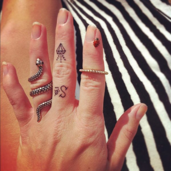Tiny Diamond Tattoo On Middle Finger