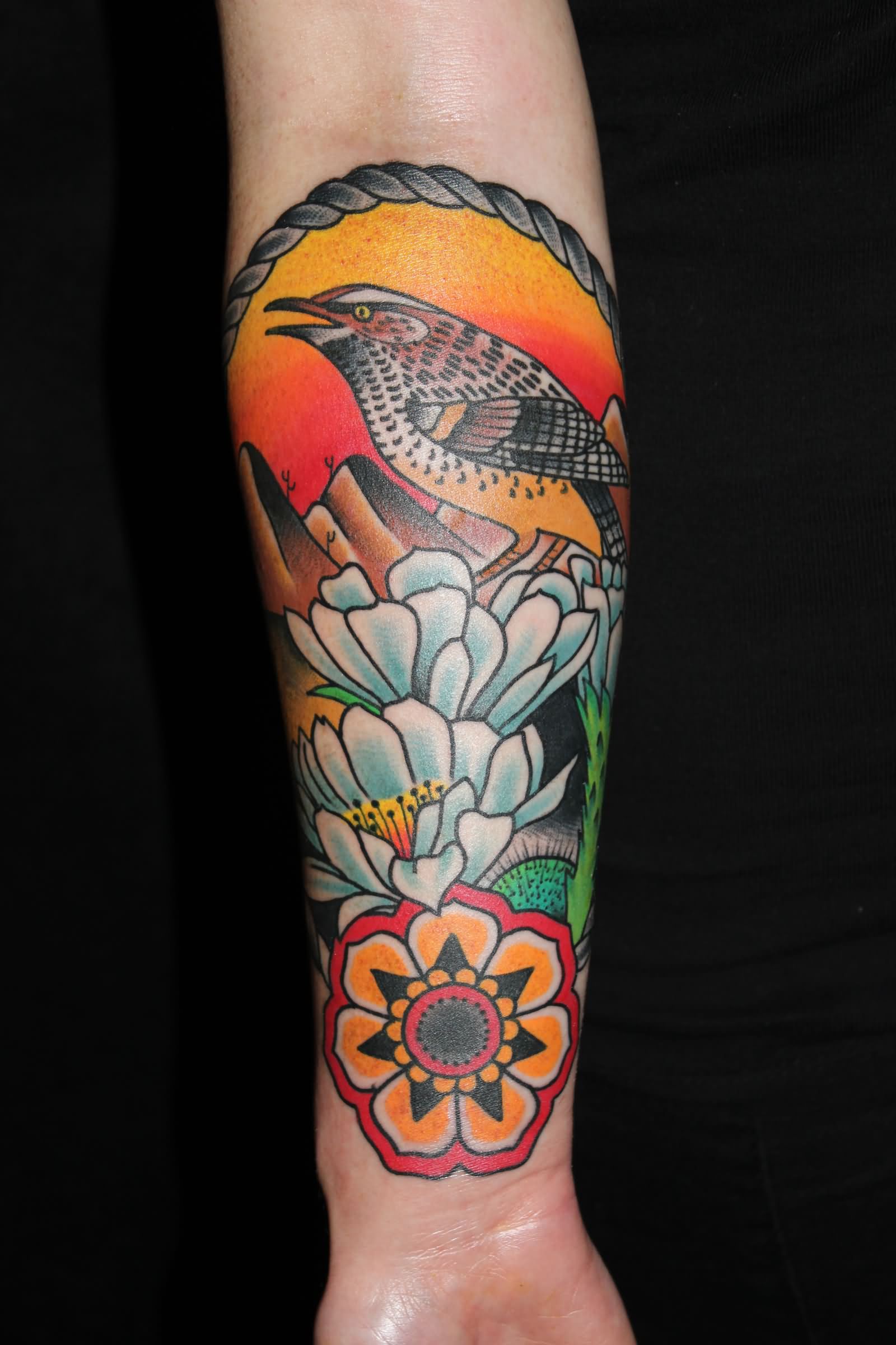 Traditional Bird With Flowers In Frame Tattoo On Forearm By Myke Chambers