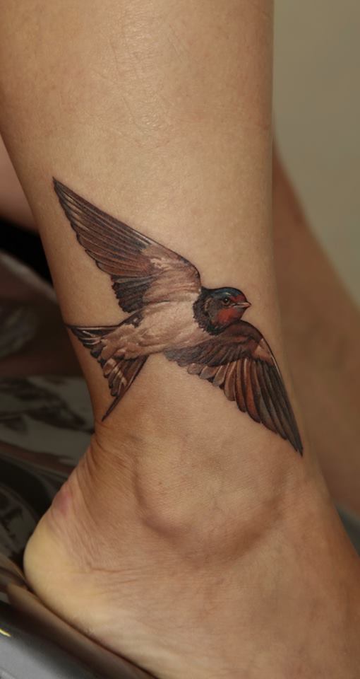 Traditional Flying Bird Tattoo On Right Ankle