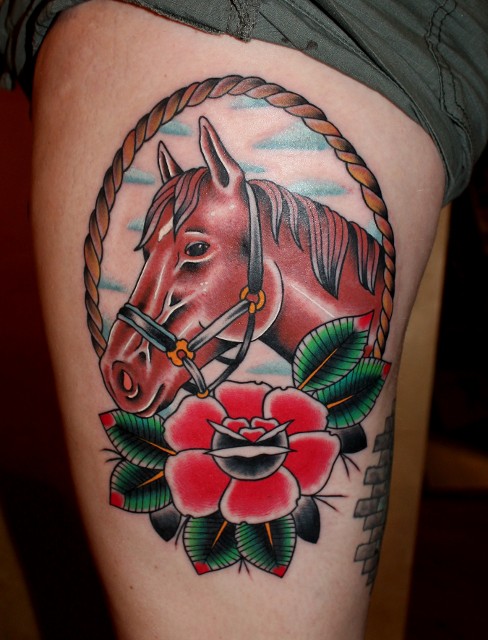 Traditional Horse In Rope Frame With Rose Tattoo On Left Thigh By Myke Chambers