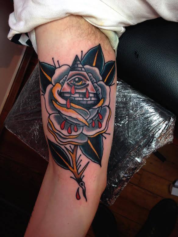 Traditional Illuminati Eye With Rose Tattoo On Right Bicep By Sam Ricketts