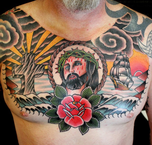 Traditional Jesus In Rope Frame With Rose Tattoo On Man Chest