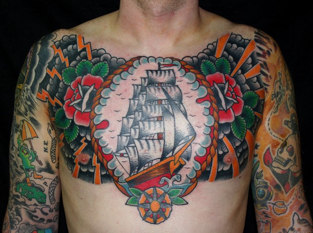 Traditional Ship In Rope Frame With Roses Tattoo On Man Chest