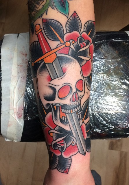 Traditional Sword In Skull With Roses Tattoo On Forearm