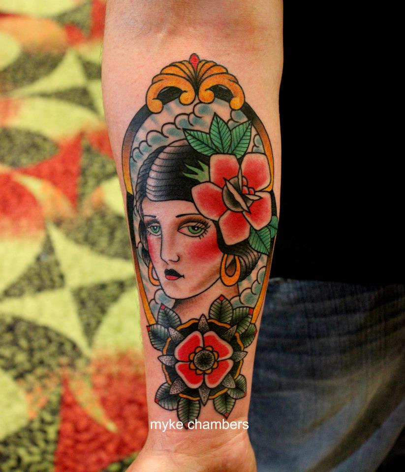 Traditional Women Head In Frame With Roses Tattoo On Right Forearm
