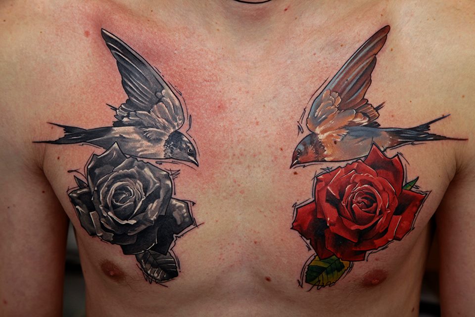 Two Flying Birds With Roses Tattoo On Man Chest