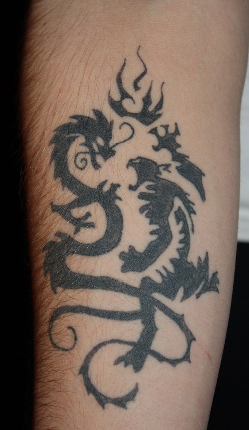 Unique Black Tribal Two Dragons Tattoo On Forearm
