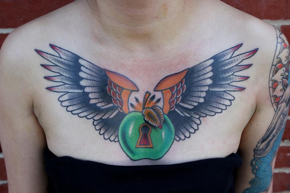 Unique Traditional Apple With Wings Tattoo On Women Collarbone