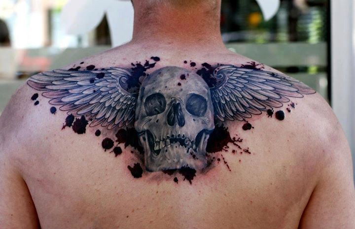 Winged 3D Skull Tattoo On Upper Back For Men