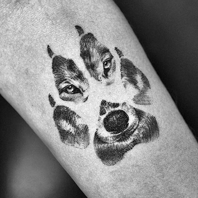Wolf Face In Paw Print Tattoo On Arm
