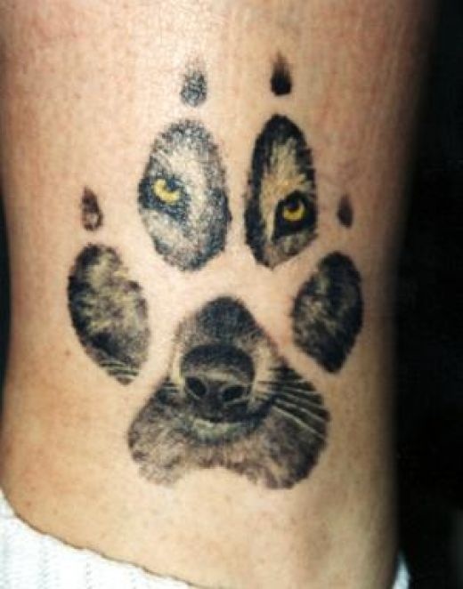 Wolf Face In Paw Tattoo On Leg
