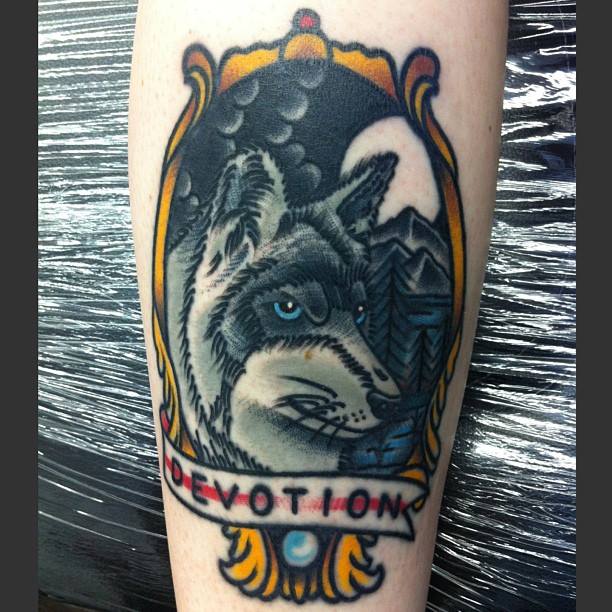 Wolf Head In Frame With Banner Tattoo On Right Sleeve By Chris Martin