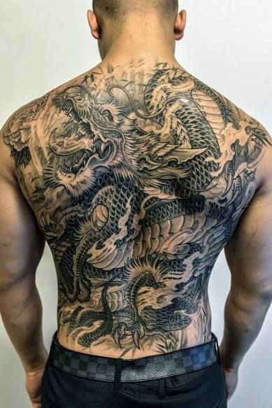Wonderful Black Ink Dragon Tattoo On Man Full Back