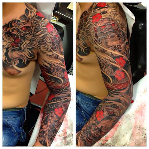 Wonderful Dragon With Flowers Tattoo On Man Left Full Sleeve