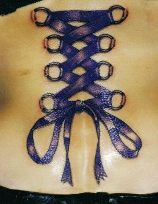 Wonderful Purple Ink Corset With Bow Tattoo On Back