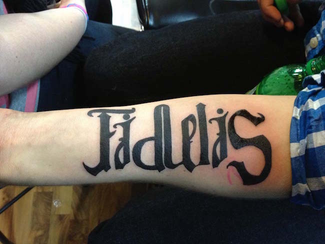 Ambigram Fidelis Tattoo On Forearm