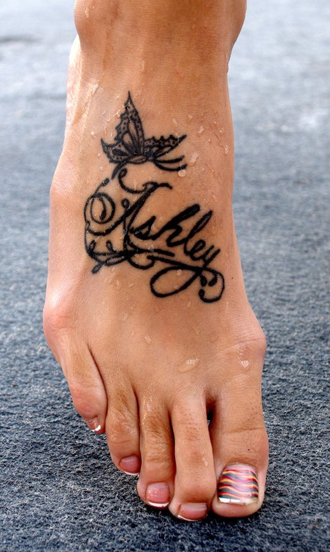 Ashley – Black Ink Flying Butterfly Tattoo On Women Right Foot