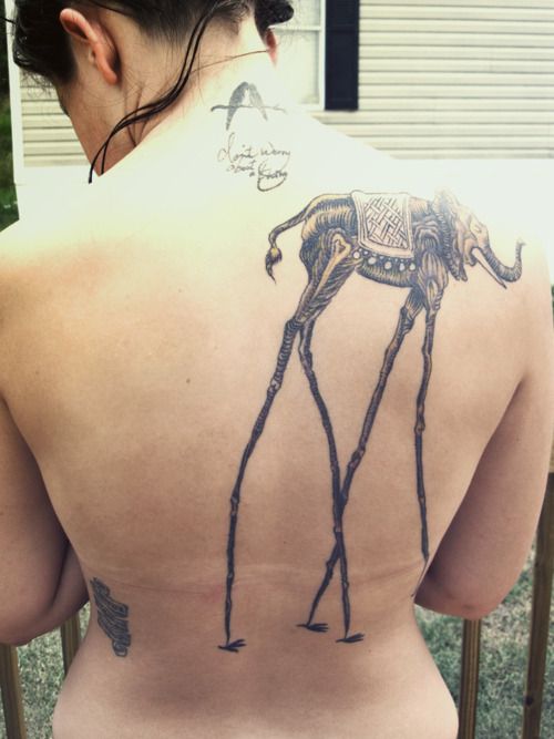 Attractive Black Ink Dali Elephant Tattoo On Women Upper Back