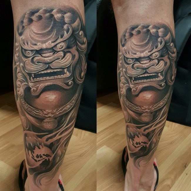 Attractive Black Ink Foo Dog Tattoo On Leg Calf