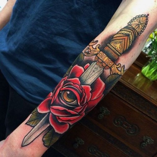 Attractive Dagger In Rose Tattoo On Left Forearm