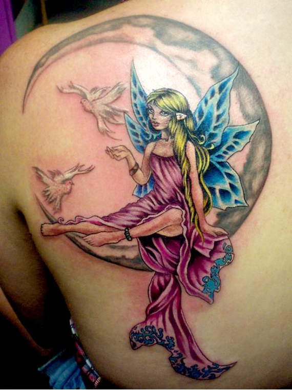 Attractive Fairy On Half Moon With Flying Birds Tattoo On Left Back Shoulder