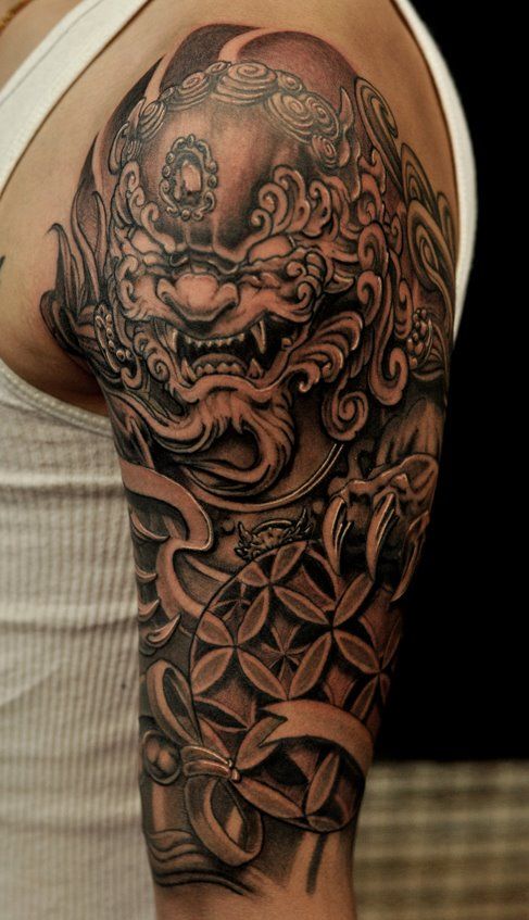 Awesome Black Ink Foo Dog Tattoo On Man Left Half Sleeve